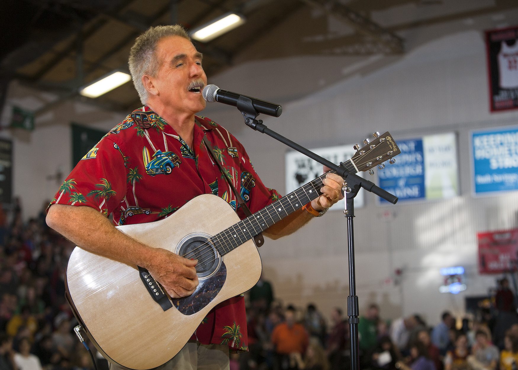 Rick Charette singing and playing guitar on stage